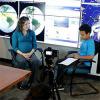 woman and man talking in an interview format in front of camera